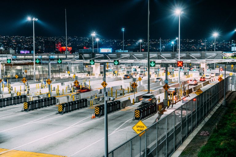 Aerial view of the Canada-United States border crossing symbolizing Canadian tax emigration.
