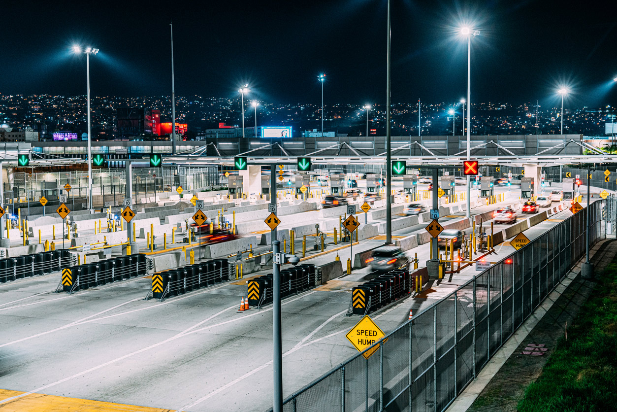 Aerial view of the Canada-United States border crossing symbolizing Canadian tax emigration.